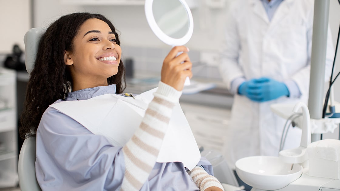 patient smiling in mirror